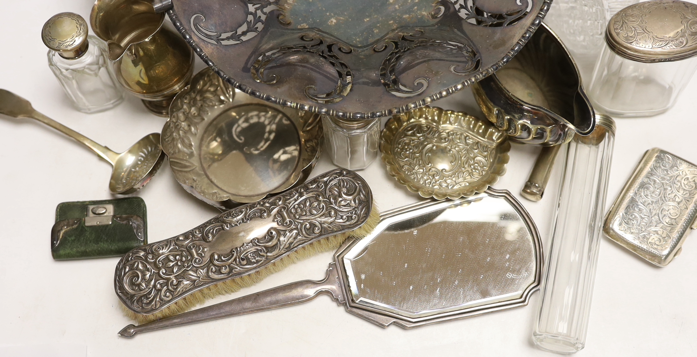 Small silver items including a pair of silver mounted cut glass scent bottles small bowl, toilet jars, mirror, brushes, cigarette case, stamp case, cream jug etc. and two plated items.